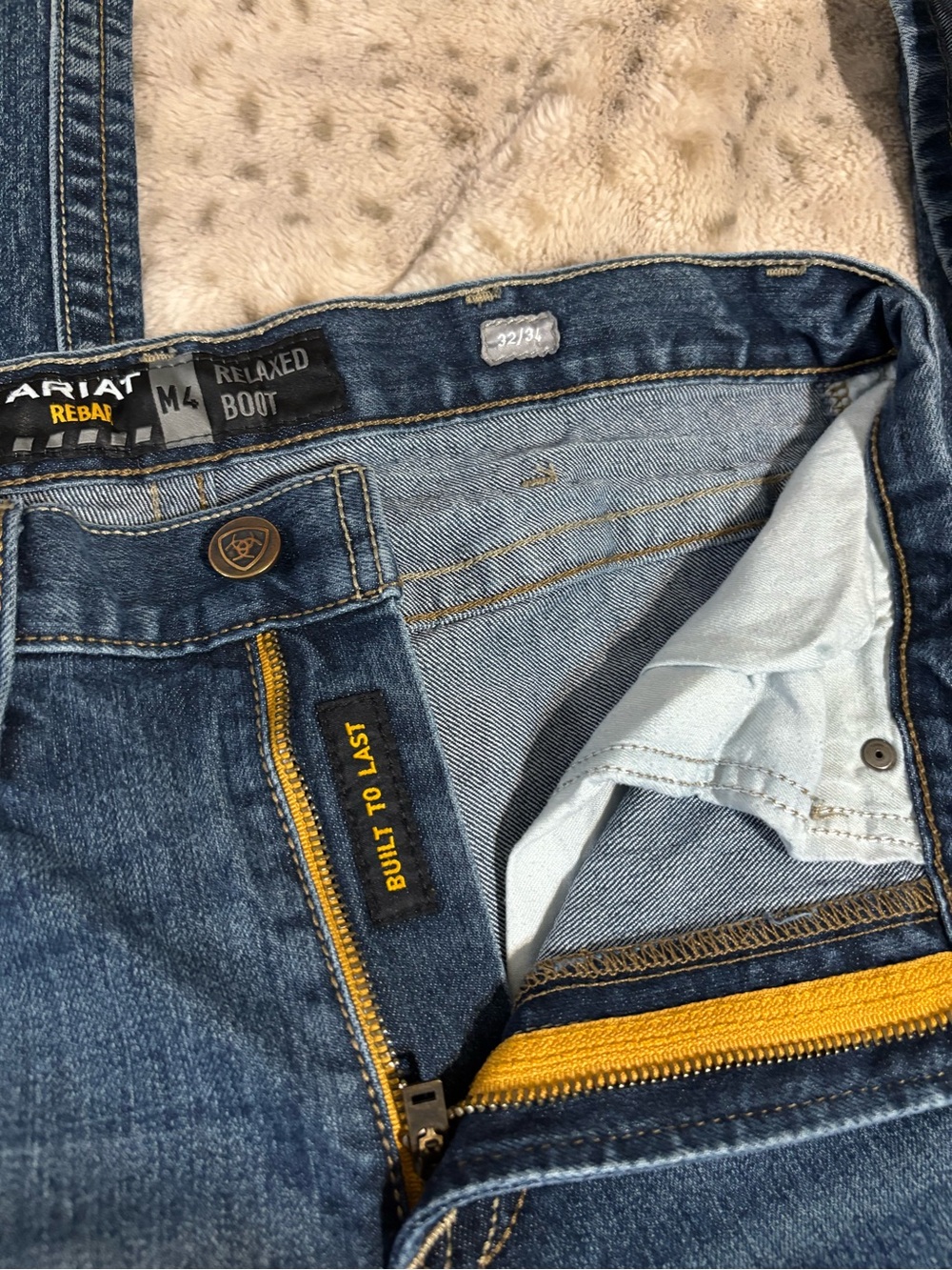 Ariat Men's Relaxed Boot Jeans in Dark Blue with Yellow Zipper Accents